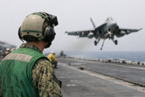 A U.S. Sailor observes flight operations during Operation Epic Fury